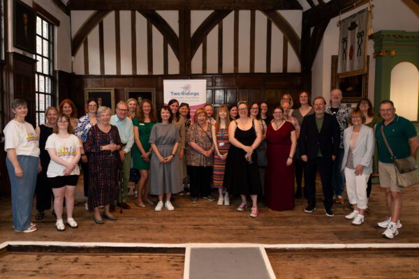 Group photo from York Community Fund event lots of people smiling at camera