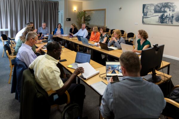 Image of a Trustee meeting taking pace in an office