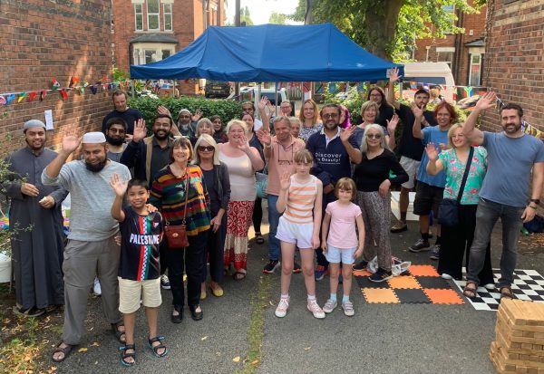 Group of residents in Hull smiling at a street party