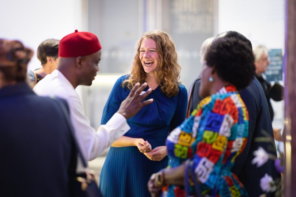 Three people smiling at an event