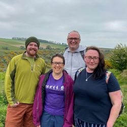 Four people smiling at the camera