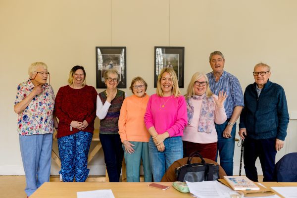 Eight people looking at the camera smiling