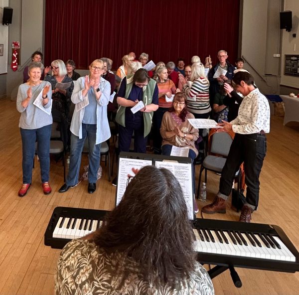 Choir singing in a village hall