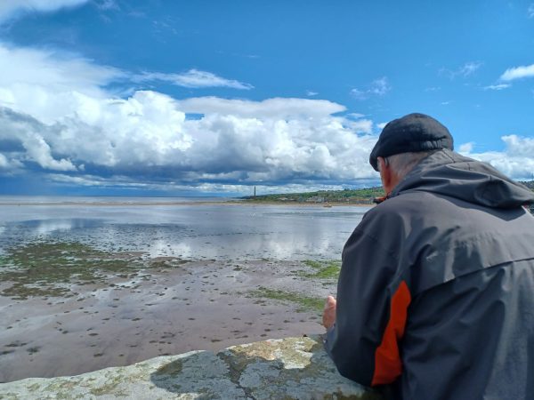 An older man looking out to the sea